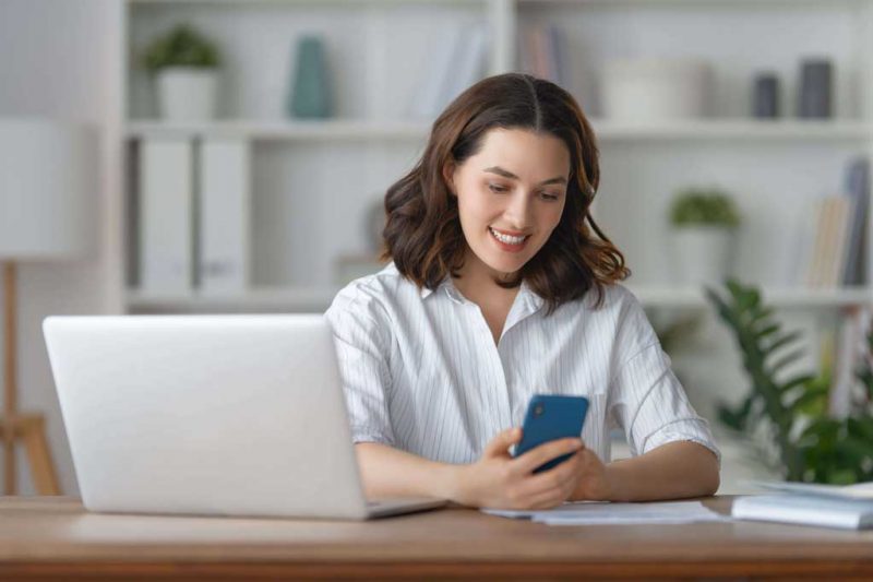 speed up windows 10: a woman using a mobile phone